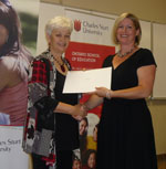 CSU Dean of Education Professor Toni Downes (left) presents an award to Ms Krista Arnold.