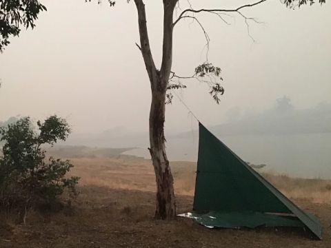 Professor Watson's tent near Lake Jindabyne. Smoke surrounds the tent and lake. 